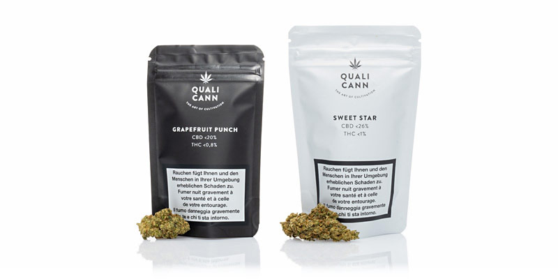 Zwei Packungen CBD-Blüten von Qualicann: Grapefruit Punch und Sweet Star.